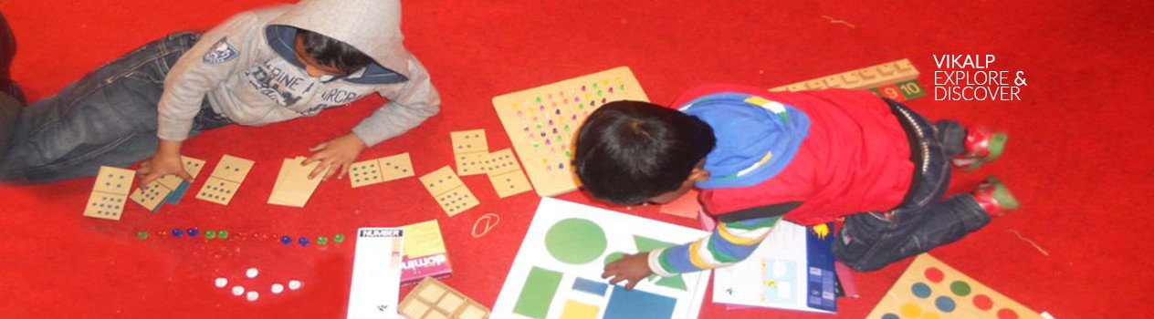 Two or three children of Pre-school are working with learning toys and discovering concepts