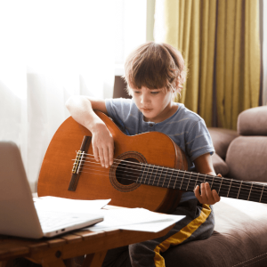 In tis image one child is learning to play guiter