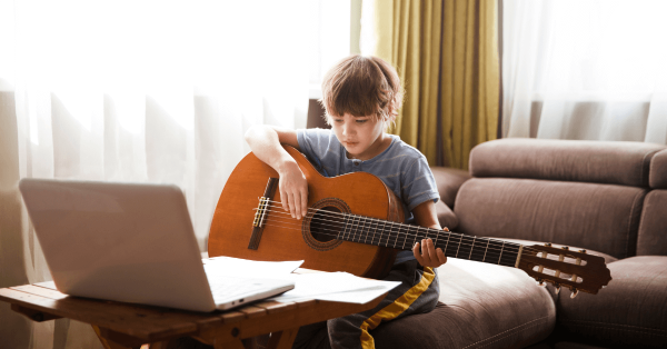 In tis image one child is learning to play guiter